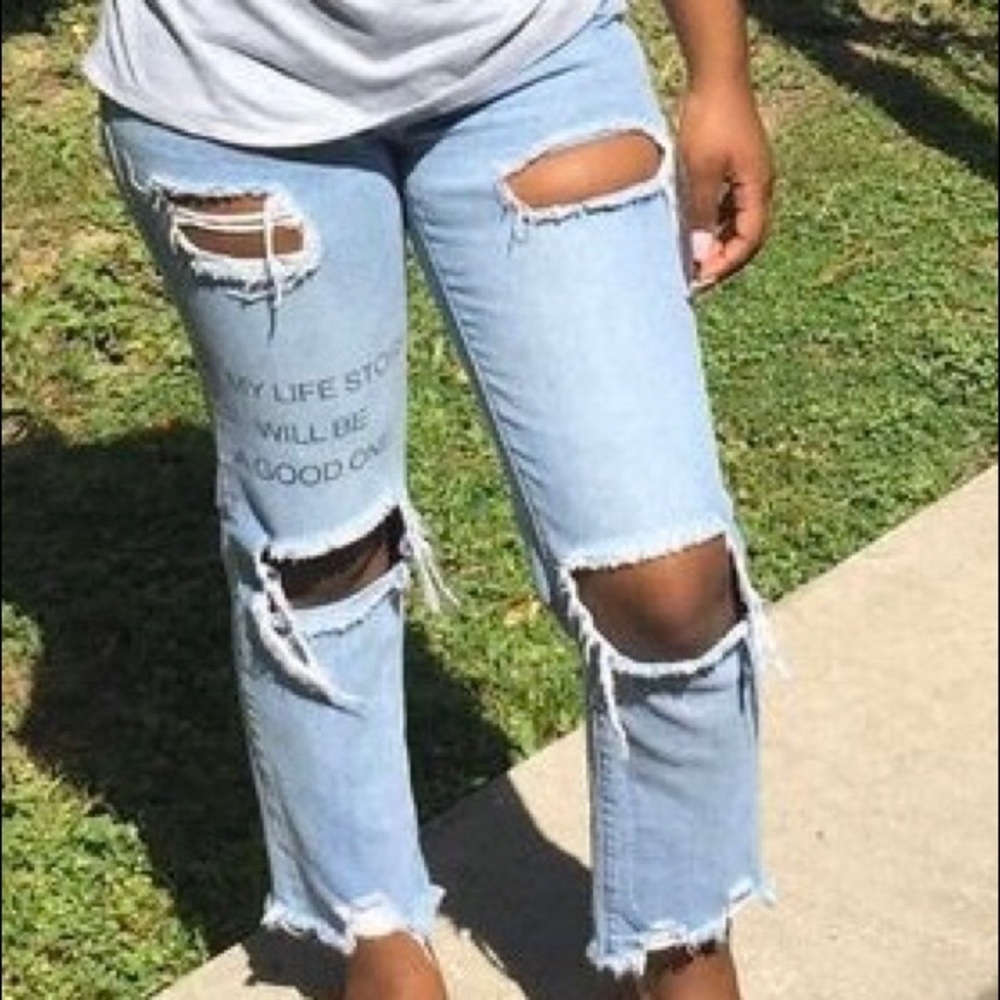 Pre-own ripped jeans with writing “my life story will be a good one